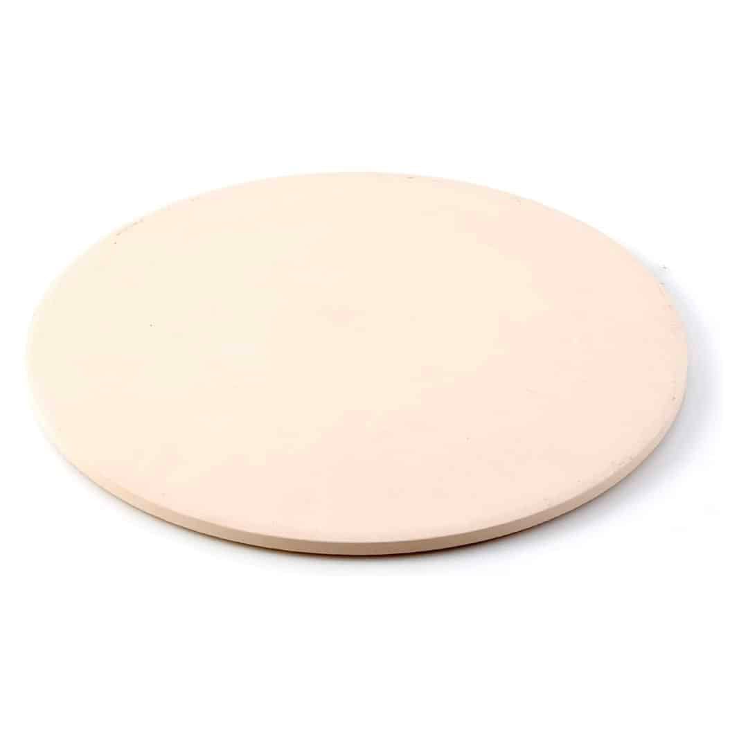 A plain, round, light beige ceramic pizza stone with smooth edges, placed on a white background—the essential tool featured in the ultimate homemade bread guide.